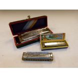 Hohner Super Chromonica harmonica, cased, together with Hohner Echo Super Vampier and Carloni
