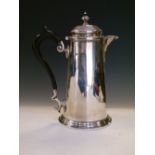 Late Victorian silver hot water jug, with ebonised scroll handle, Sheffield 1895, 20cm high, 13.3toz