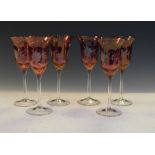 Set of six flashed cranberry glass wines having etched floral decoration, 19cm high