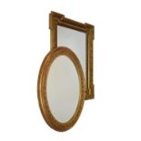 Two modern reproduction bevelled glass gilt framed mirrors, the oval overall 86cm x 67cm, the