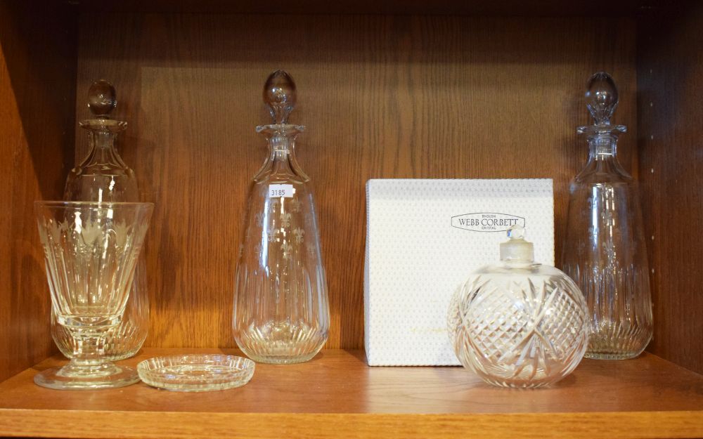 Set of three cut glass decanters having fleur-de-lys engraved decoration, 26.5cm high a glass
