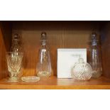 Set of three cut glass decanters having fleur-de-lys engraved decoration, 26.5cm high a glass