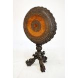 19th Century Burmese hardwood carved tilt-top tripod table, the circular top with border carved