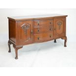 Early 20th Century mahogany sideboard, of bow-breakfront design with three curved drawers flanked by