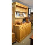 Modern light oak dresser, the plate rack fitted two galleried shelves, the base with three short