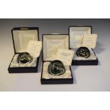 Three Caithness glass limited edition paperweights comprising Christmas 1977 (415/500), Floral