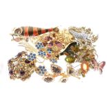 Assorted costume brooches to include stag, fish, butterfly, donkey and cart, swan, cat etc
