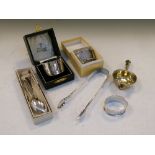 Assorted silver to include; sugar tongs, tea strainer, three napkin rings, set of five Hanoverian