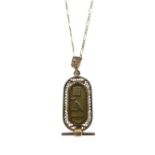 Egyptian yellow metal pendant decorated with hieroglyphics, 5.3g approx, together with an unmarked