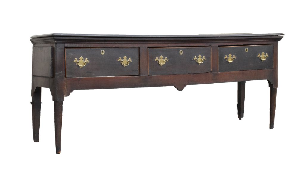18th Century oak dresser base fitted three drawers with brass swan neck handles, raised on turned