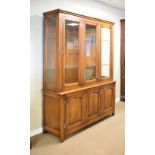 Good quality reproduction oak two section display cabinet fitted three adjustable glass shelves