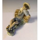 Lladro porcelain figure of a shepherd boy resting with bird on his foot, 20cm long
