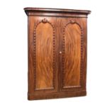 Good quality Victorian mahogany double wardrobe having shaped moulded cornice above two arched panel