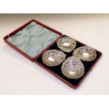 Cased set of four late Victorian silver bon bon dishes, each of pierced design with repoussé