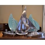 Three Art Deco style cast metal yachts, a chrome-plated cruet set, and a pair of French turquoise