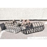 Pair of wrought metal hay baskets and four composite stone garden ornaments