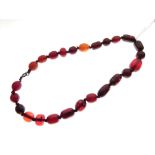 String of pressed amber beads, 39.5cm long, 29.6g gross approx