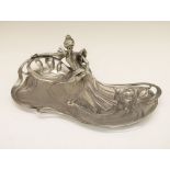 Reproduction Art Nouveau design pewter dish depicting a reclining lady reading a book, the base with