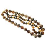 String of tumbled amber beads and one other string of composite amber beads, 135g gross approx