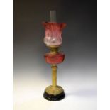 Victorian brass oil lamp having cut cranberry glass reservoir with frosted etched pink shade,