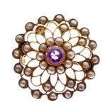Floral design brooch set seed pearls and central amethyst, stamped 15ct, 3.5g gross approx