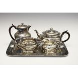 Early 20th Century Arts & Crafts-style planished pewter tea service, the hot water jug 17.5cm