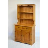 Yellow pine dresser and rack of narrow proportions, the planked shaped rack with two shelves over