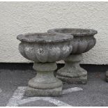 Pair of reconstituted garden urns of gadrooned pedestal design, 39cm diameter and height