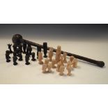 African carved wooden chess set, natural and stained, comprising figures, giraffes, huts etc,
