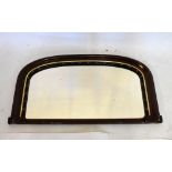 Late Victorian walnut overmantel mirror, the arched plain plate within Gothic-style border and