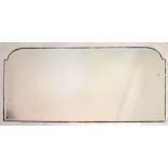 Bevelled frameless overmantel mirror of broken arch design, 149cm wide x 78cm high