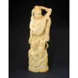 Japanese Meiji period ivory okimono modelled as a female musician standing over a dragon, 21.5cm