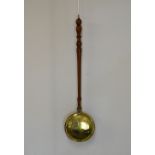 Antique brass warming pan with punch-decorated cover and turned wooden handle, 103cm long