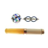 White metal and enamel bar brooch, millefiori brooch, and cigarette holder or filter with 18ct