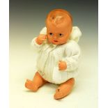 Vintage 20th Century composite doll, in white knitted outfit, with hand-painted eyes and lips,