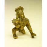 Indian bronze figure of a crouching deity holding an orb, 11.5cm high