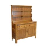 Ercol light elm sideboard, fitted two drawers over two cupboard doors with plate rack, 120cm wide