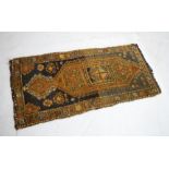 Directional prayer rug with red border against a blue ground, 118cm x 58cm