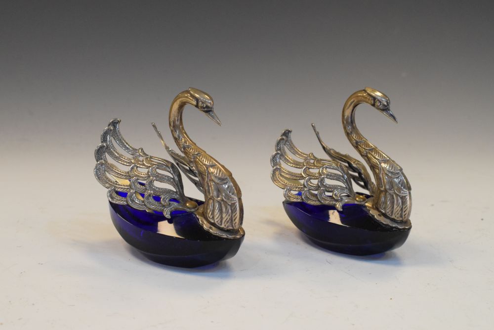 Pair of Continental white metal and blue glass swan-form salts, each stamped 800, with pierced