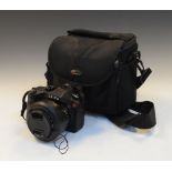 Leica digital camera with 25/400mm zoom lens and SD card in camera bag