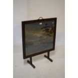 Early 20th Century oak framed firescreen having woven silk panel of an Oriental coastal scene,