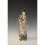 Japanese porcelain figure of a bijin in typical dress, holding flowers, standing on floral base,