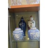 Two Oriental vases, both with covers, 31cm high, together with two blue and white ginger jars with