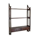 Mahogany Regency-style wall hanging shelves having metal grille end supports, fitted two drawers