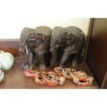 Pair of ornately carved hardwood Indian elephants and two other gilt decorated carvings of exotic