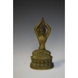 South East Asian bronze figure of a deity with hands clasped over head in prayer, 21cm high