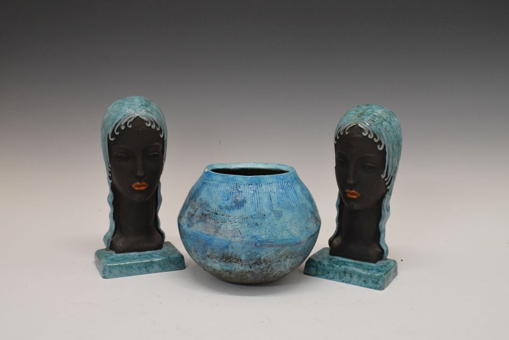 Pair of turquoise glazed pottery bookends formed as stylised female heads, together with a similarly