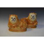 Pair of Staffordshire pottery lions, 23cm high