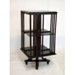 Ebonised beech square revolving book table, 45cm x 45cm x 92cm high