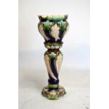 Early 20th Century majolica jardinière and stand having decoration of acanthus against a blue